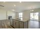 Bright, open kitchen island and living room space with hardwood flooring and a fireplace at 3505 Triad Ct, Raleigh, NC 27604