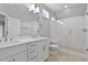 Bathroom with double vanity, a glass-enclosed shower with bench, and a window for natural light at 3909 Cedar Knolls Dr # 6, Youngsville, NC 27596