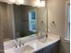 Bathroom featuring double vanity, large mirror, and a window at 3909 Cedar Knolls Dr # 6, Youngsville, NC 27596