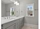 Bright bathroom featuring a double vanity with quartz countertops and a garden view window at 3909 Cedar Knolls Dr # 6, Youngsville, NC 27596