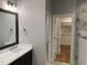 Bathroom with large mirror, modern fixtures, and a walk-in closet adjacent to the shower at 3909 Cedar Knolls Dr # 6, Youngsville, NC 27596