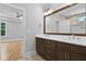 Modern bathroom featuring a double vanity with quartz countertops and a large mirror at 3909 Cedar Knolls Dr # 6, Youngsville, NC 27596