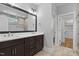 Bathroom featuring a double vanity with quartz countertops, stylish fixtures, and a walk-in closet at 3909 Cedar Knolls Dr # 6, Youngsville, NC 27596