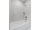 Modern tub and shower combo with a tile surround and built-in shelving at 3909 Cedar Knolls Dr # 6, Youngsville, NC 27596