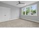 Bedroom featuring neutral walls, carpeting, a double door closet, and a large window at 3909 Cedar Knolls Dr # 6, Youngsville, NC 27596