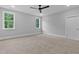 Bedroom featuring neutral walls, carpeting, two large windows, and a ceiling fan at 3909 Cedar Knolls Dr # 6, Youngsville, NC 27596