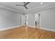 Spacious bedroom featuring hardwood floors, a ceiling fan, and access to other rooms at 3909 Cedar Knolls Dr # 6, Youngsville, NC 27596