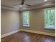 Spacious bedroom with hardwood floors, two windows with views, and neutral paint at 3909 Cedar Knolls Dr # 6, Youngsville, NC 27596