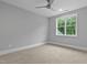 Bedroom featuring neutral walls, carpeting, and a large window providing views of the surrounding homes at 3909 Cedar Knolls Dr # 6, Youngsville, NC 27596