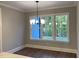 Dining room has hardwood floors, neutral walls, and a window with views of a wooded area at 3909 Cedar Knolls Dr # 6, Youngsville, NC 27596