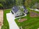 New construction home featuring a landscaped yard, long driveway, and gray siding at 3909 Cedar Knolls Dr # 6, Youngsville, NC 27596