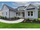 Charming new construction home with meticulous landscaping, gray siding, and stylish architecture at 3909 Cedar Knolls Dr # 6, Youngsville, NC 27596