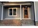 Home exterior featuring a stone porch and a wood front door at 3909 Cedar Knolls Dr # 6, Youngsville, NC 27596