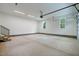 Spacious garage with LED lighting, stairs leading to an upper level, and two windows at 3909 Cedar Knolls Dr # 6, Youngsville, NC 27596
