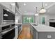 Spacious kitchen with stainless appliances, center island, and view to outdoor scenery at 3909 Cedar Knolls Dr # 6, Youngsville, NC 27596