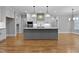Bright kitchen featuring a large island, stainless appliances, and pendant lighting at 3909 Cedar Knolls Dr # 6, Youngsville, NC 27596