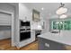 Modern kitchen featuring white cabinets, stainless steel appliances, and a large island with counter seating at 3909 Cedar Knolls Dr # 6, Youngsville, NC 27596