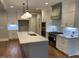Island kitchen with white cabinets, stainless appliances, and hardwood floors at 3909 Cedar Knolls Dr # 6, Youngsville, NC 27596