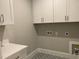 Well-lit laundry room with ample storage and modern patterned floor at 3909 Cedar Knolls Dr # 6, Youngsville, NC 27596