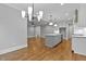 Bright kitchen and dining area featuring hardwood floors, stainless appliances and stylish lighting at 3909 Cedar Knolls Dr # 6, Youngsville, NC 27596