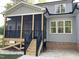 Covered porch with stairs and black railings overlooks the backyard at 3909 Cedar Knolls Dr # 6, Youngsville, NC 27596