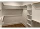Walk-in closet with wood rods, and shelves provides ample space for storage at 3909 Cedar Knolls Dr # 6, Youngsville, NC 27596