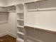 Walk-in closet with wood rods, and shelves provides ample space for storage at 3909 Cedar Knolls Dr # 6, Youngsville, NC 27596