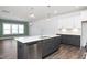 Kitchen island featuring a stainless-steel dishwasher, sink, seating, stylish pendant and recessed lighting at 3920 Willow Gate Way, Raleigh, NC 27604