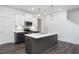 Well-appointed kitchen featuring a center island with sink, stainless steel appliances, and pendant lighting at 3920 Willow Gate Way, Raleigh, NC 27604