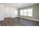 Inviting living room boasts natural light with wood-look flooring and a view to the yard at 3920 Willow Gate Way, Raleigh, NC 27604