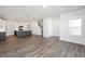 Open-concept living area features wood-look floors, kitchen view and staircase to the second floor at 3920 Willow Gate Way, Raleigh, NC 27604