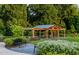 Community pavilion set in a green space, featuring outdoor seating and a lush landscape, perfect for residents at 3920 Willow Gate Way, Raleigh, NC 27604