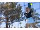 Active Personal hitting pickleball on court with trees and blue sky background at 3920 Willow Gate Way, Raleigh, NC 27604