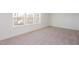 Bright, carpeted bedroom with a large window offering ample natural light at 3928 Willow Gate Way, Raleigh, NC 27604