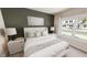 Serene bedroom with a large window, soft lighting, neutral color scheme, and comfortable furniture at 3928 Willow Gate Way, Raleigh, NC 27604