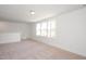 Carpeted bonus room with a large window providing natural light at 3928 Willow Gate Way, Raleigh, NC 27604