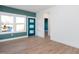 Entryway features a teal door, wood-look floors, and large windows letting in natural light at 3928 Willow Gate Way, Raleigh, NC 27604