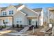 Charming townhome features gray siding, a blue front door, and well-manicured landscaping at 3928 Willow Gate Way, Raleigh, NC 27604