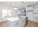 Bright kitchen featuring stainless steel appliances, black faucet, and elegant pendant lighting at 3928 Willow Gate Way, Raleigh, NC 27604
