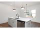 Bright kitchen featuring stainless steel appliances, black faucet, and elegant pendant lighting at 3928 Willow Gate Way, Raleigh, NC 27604