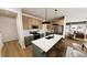Stylish kitchen with white countertops, stainless steel appliances, a center island, and modern pendant lighting at 3928 Willow Gate Way, Raleigh, NC 27604
