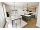 Open-concept kitchen and dining area featuring modern lighting, countertops, and stainless steel appliances at 3928 Willow Gate Way, Raleigh, NC 27604