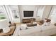 Bright and airy living room featuring hardwood floors, neutral decor, large windows, and stylish furniture at 3928 Willow Gate Way, Raleigh, NC 27604