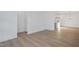 Open living area with wood floors and modern lighting fixtures, leading into the kitchen at 3928 Willow Gate Way, Raleigh, NC 27604