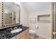 Bathroom features a granite countertop, a large mirror, and a shower with tile surround at 4 Ventana Ct, Durham, NC 27712