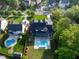 Aerial shot of a home with a backyard pool and playground, surrounded by lush trees and landscaping at 4329 Lambeth Dr, Raleigh, NC 27609