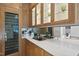 Wet bar featuring custom cabinets, granite countertops, mirrored backsplash, and wine refrigerator at 4329 Lambeth Dr, Raleigh, NC 27609