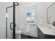 Modern bathroom featuring a glass-enclosed shower and stylish black and white accents at 4329 Lambeth Dr, Raleigh, NC 27609