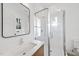 Modern bathroom features glass shower, white subway tile, new fixtures and a wood vanity at 4329 Lambeth Dr, Raleigh, NC 27609