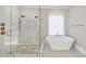 Luxurious bathroom with a freestanding tub, walk-in shower, and modern fixtures at 4329 Lambeth Dr, Raleigh, NC 27609